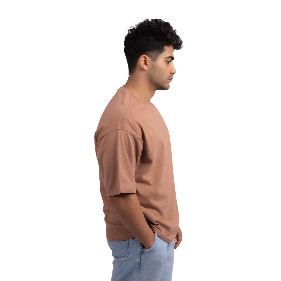 Unisex oversized Driftwood brown t-shirt side view – premium oversized tee with a breathable cotton blend and a relaxed silhouette.